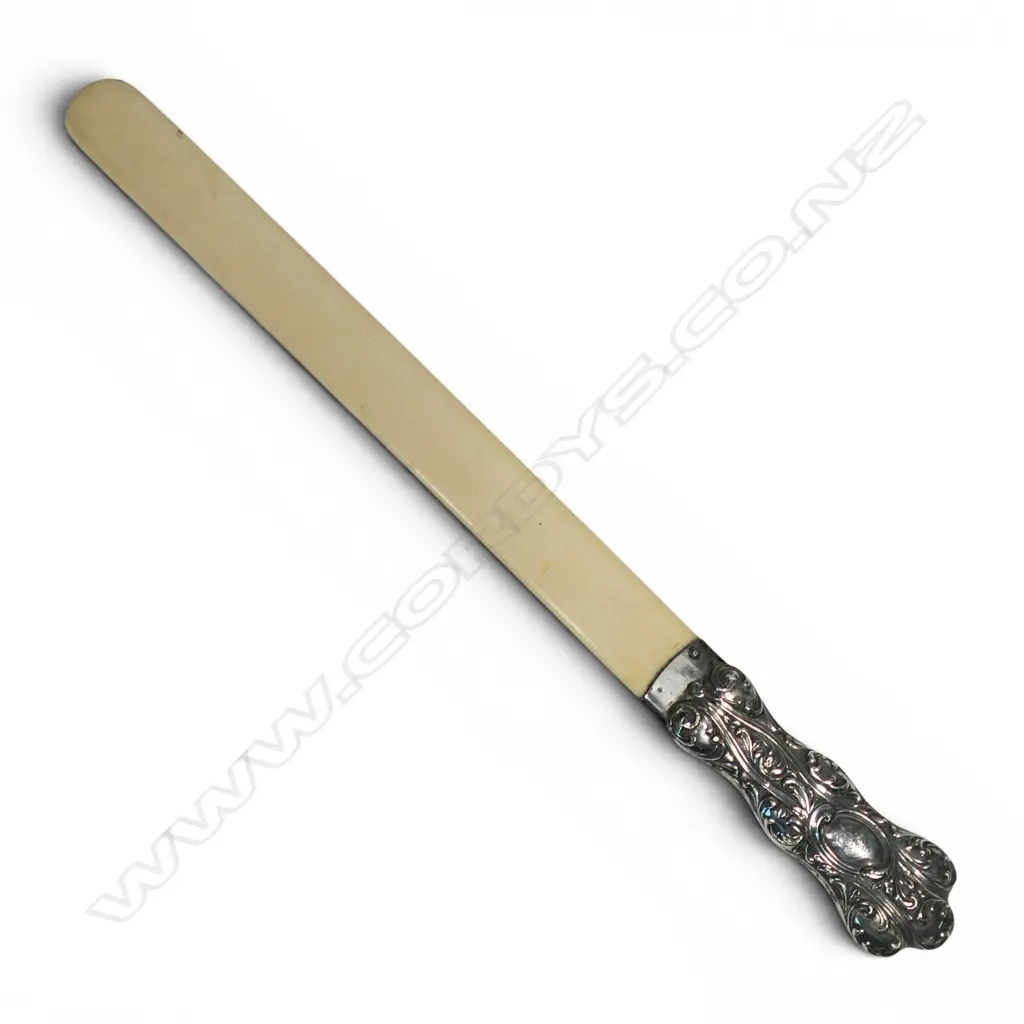 A late Victorian embossed silver handled ivory long page turner, Image 1++