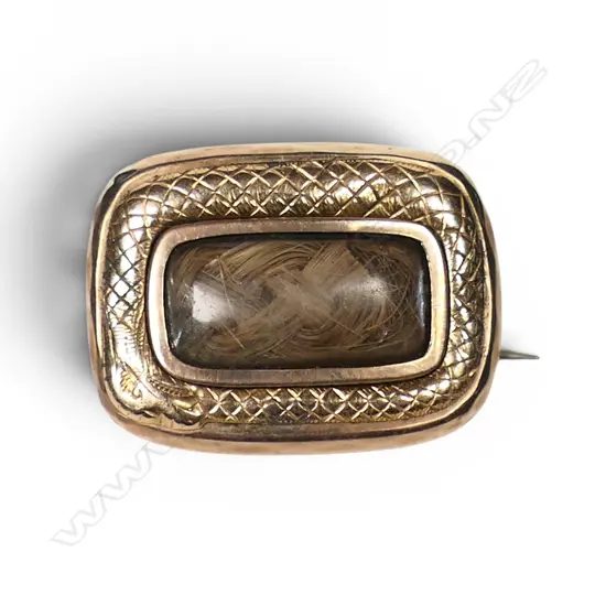 An early 19thC 9ct gold mourning brooch with looping snake,