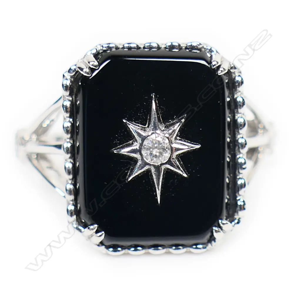 A 14ct white gold onyx and diamond dress ring, Image 1++