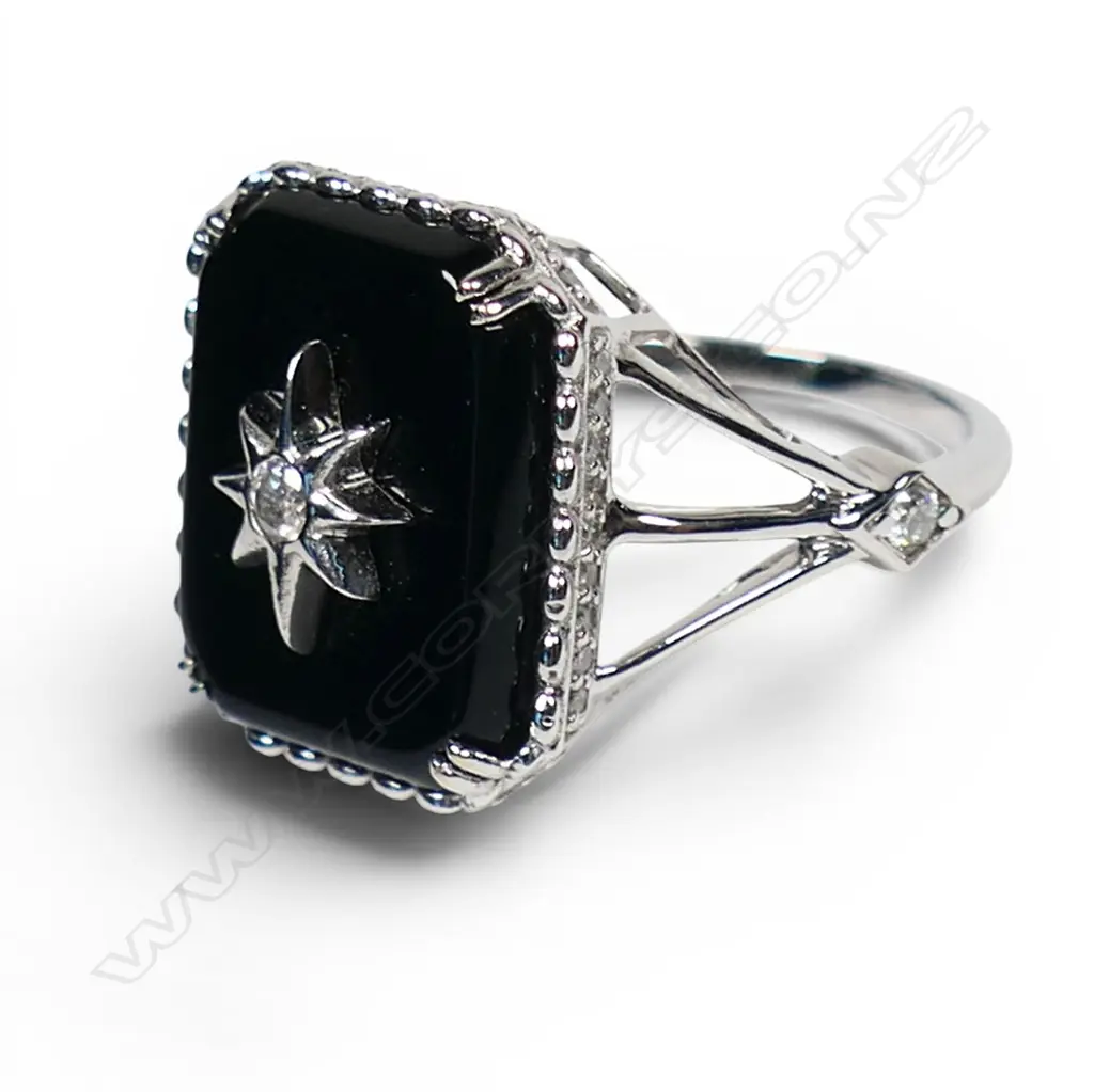 A 14ct white gold onyx and diamond dress ring, Image 1++