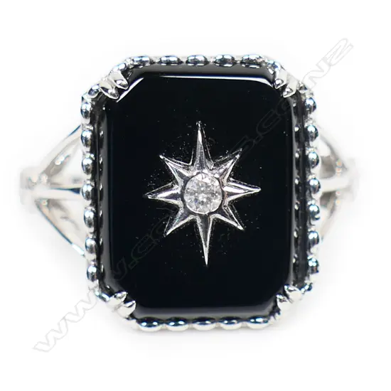 A 14ct white gold onyx and diamond dress ring,