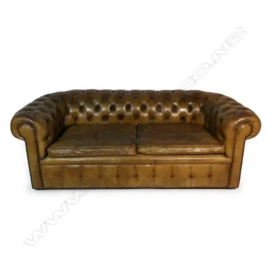 A vintage tan leather button back Chesterfield,