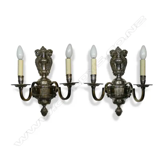 A pair of early 20thC silver plate figural wall sconces,