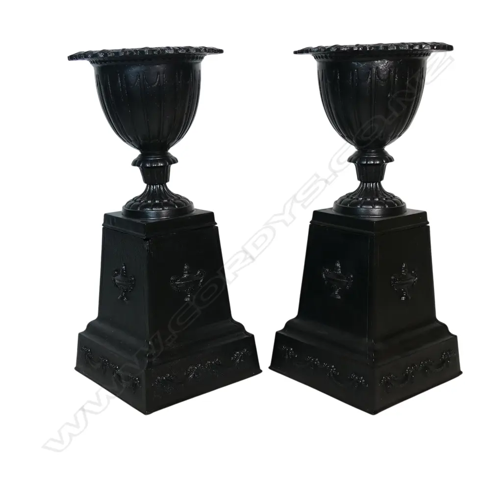 A pair of old refurbished cast iron urns on plinth bases, Image 1++