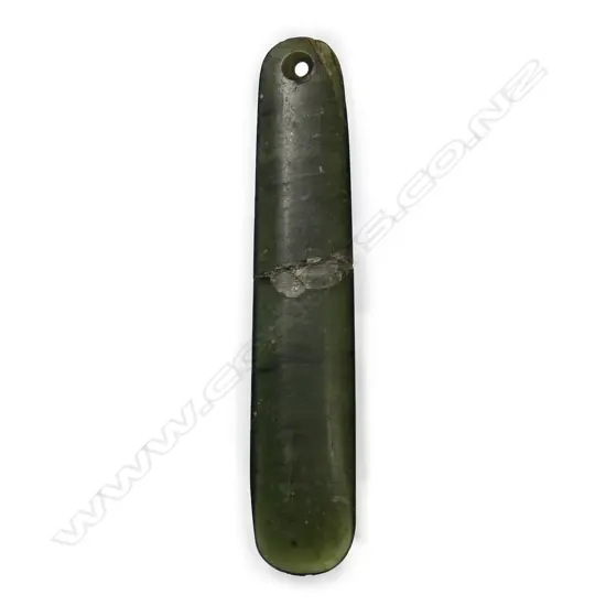 An old Māori pounamu (bowenite/tangiwai) kuru (pendant),