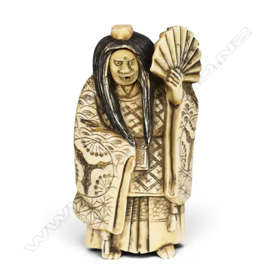 An early 20thC Japanese carved ivory okimono figure of a revolving head Noh actor,