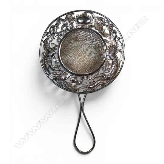 A Chinese silver dragon embossed tea strainer,