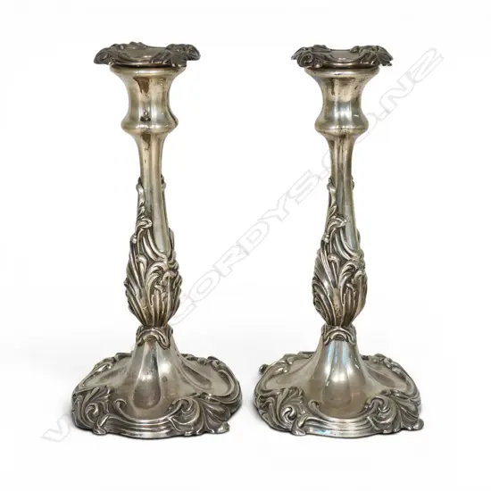 A pair of large loaded silver column candlesticks,