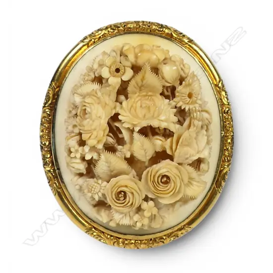 A 19thC deeply floral carved ivory large brooch,