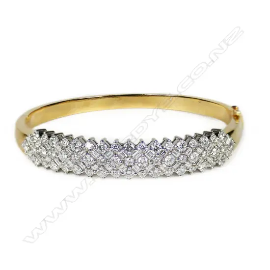An impressive 18ct-tone gold and multi diamond hinged bangle,