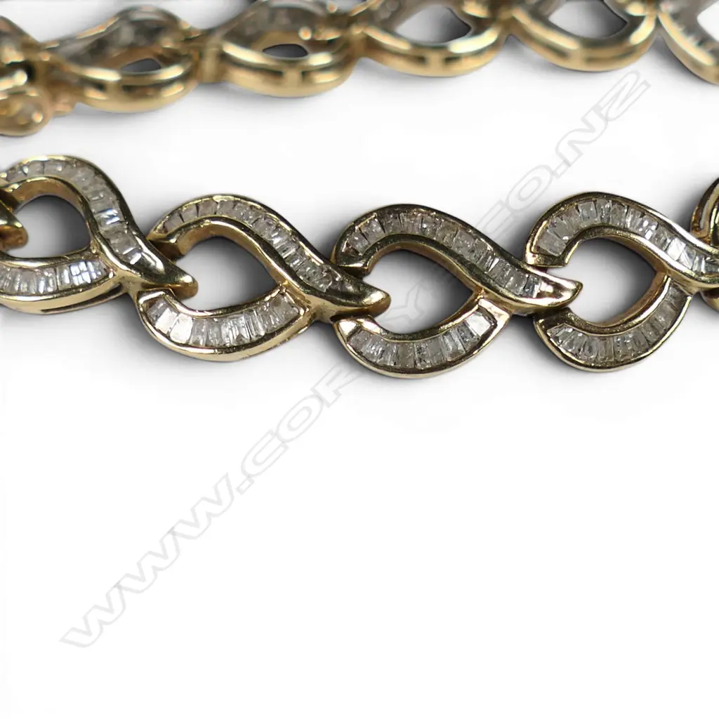 A 10ct yellow gold and multi baguette diamond set bracelet, Image 1++