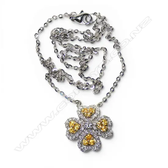 An 18ct white yellow and white diamond pendant,