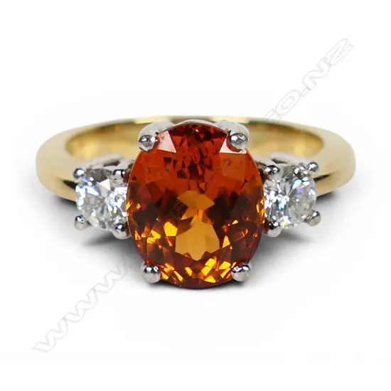 An 18ct yellow and white gold orange garnet and diamond dress ring,