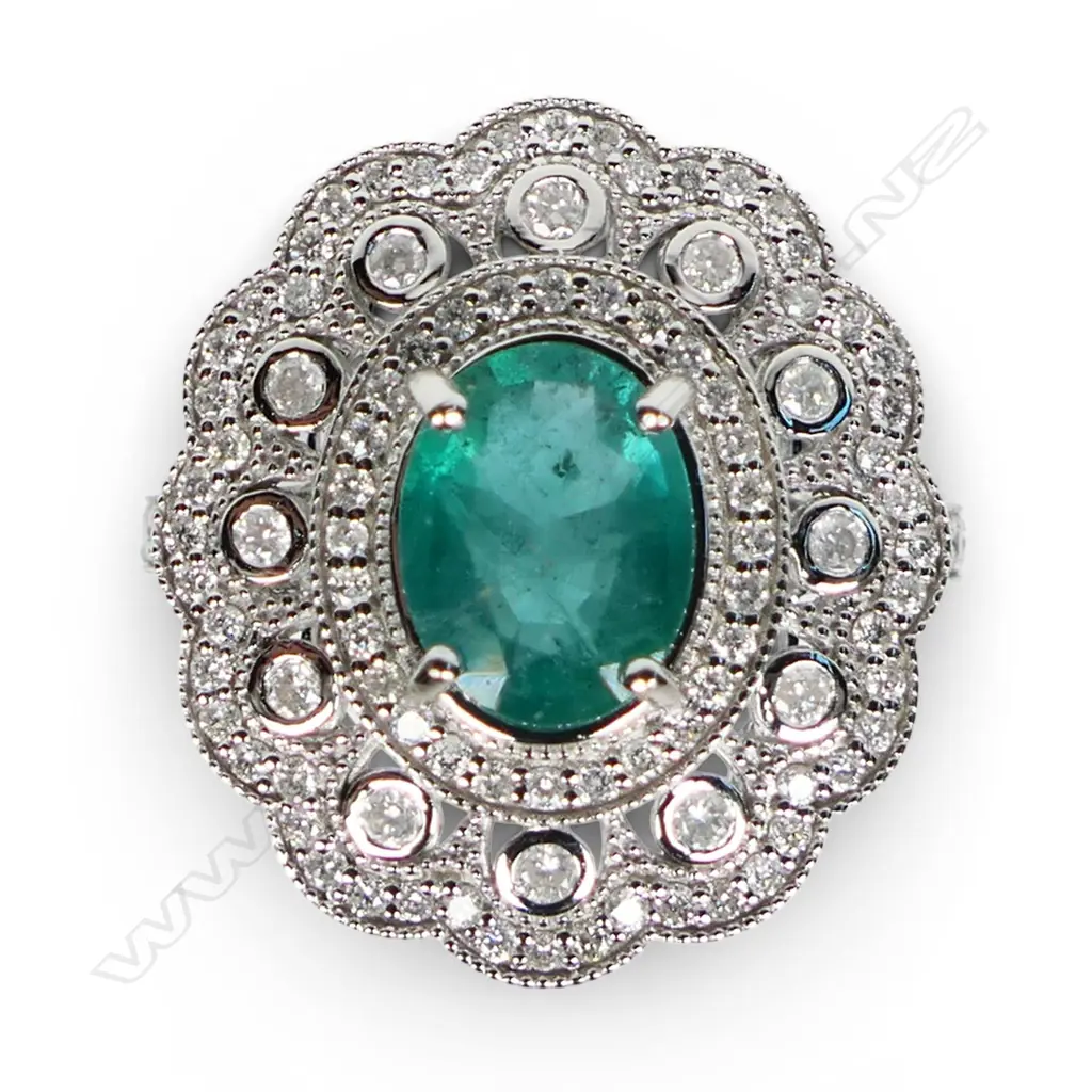A 14ct white gold emerald and diamond cluster ring, Image 1++