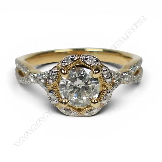 A 14ct gold and diamond ornate halo ring,