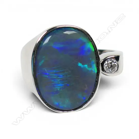 A 14ct white gold opal and diamond ring,