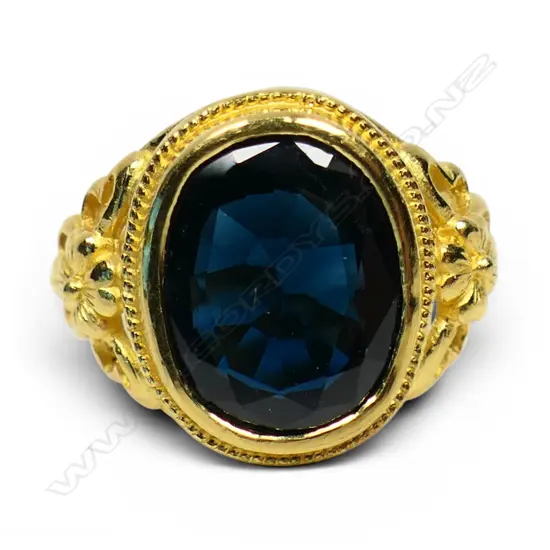A 22ct yellow gold and large dark sapphire ring,