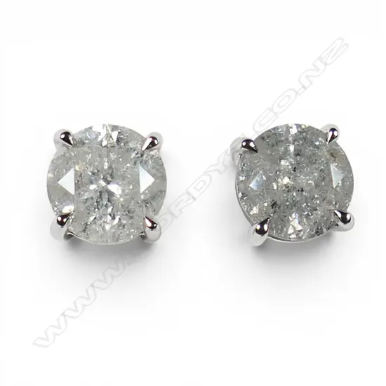 A pair of 14ct white gold and diamond stud earrings,
