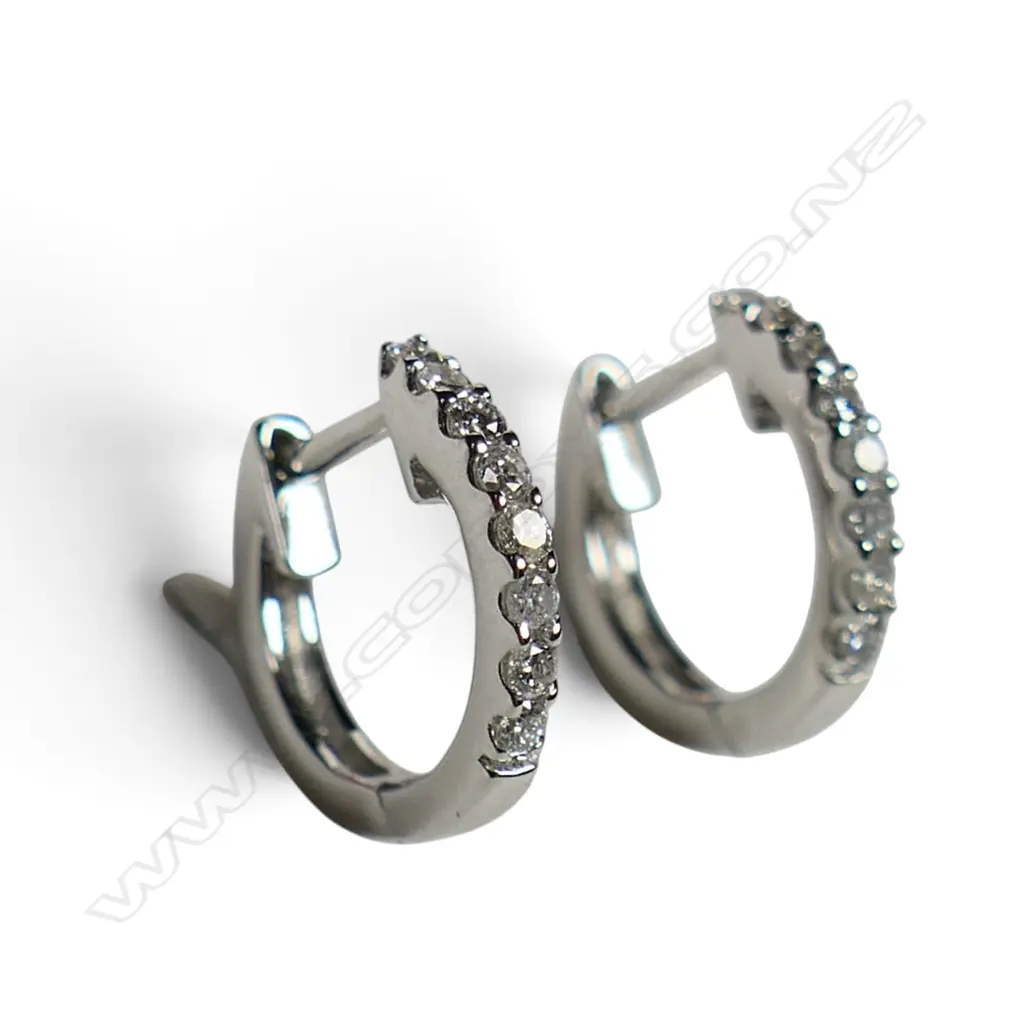 A pair of 18ct white gold and diamond huggie earrings, Image 1++