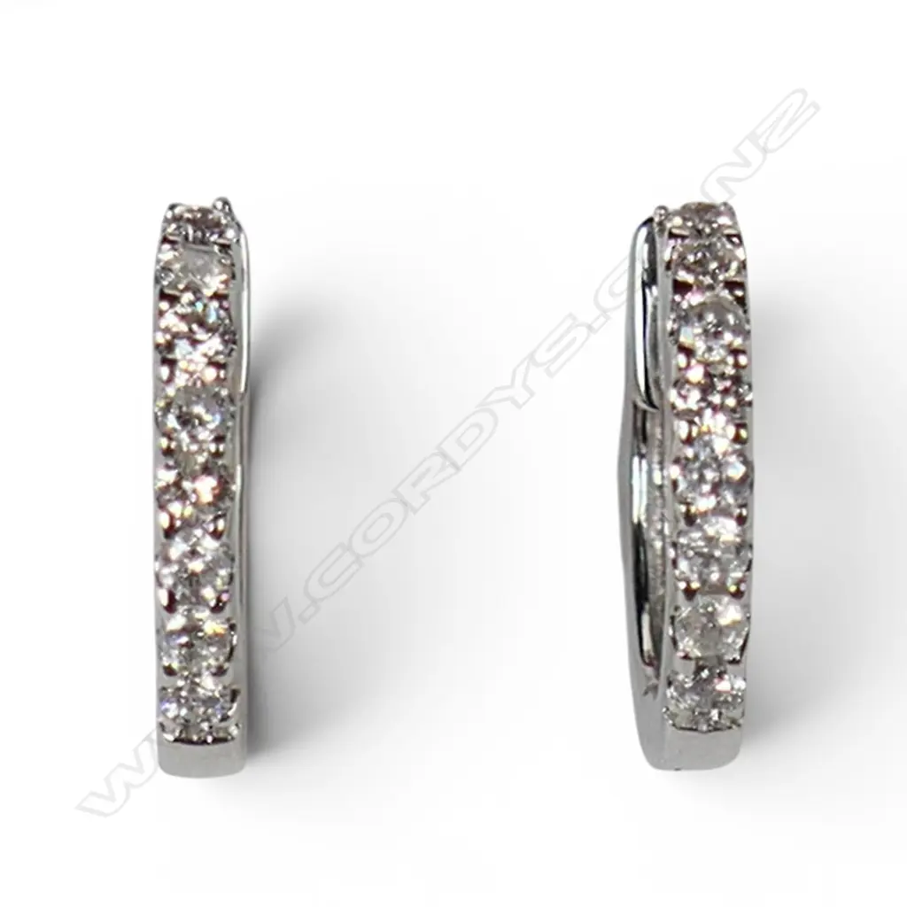 A pair of 18ct white gold and diamond huggie earrings, Image 1++