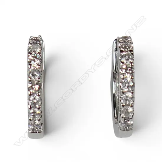 A pair of 18ct white gold and diamond huggie earrings,