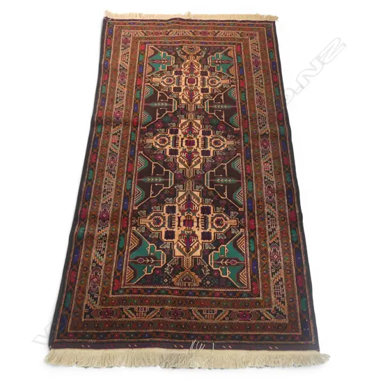 A hand-knotted Baloch rug,