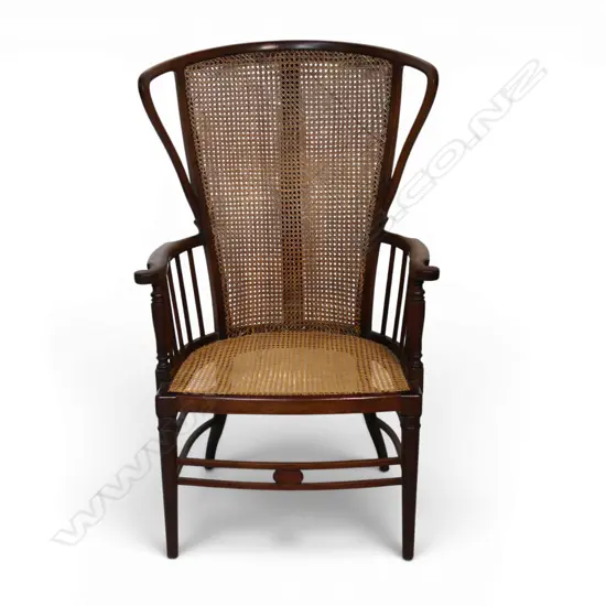 An Edwardian Wycombe cane wing back chair,