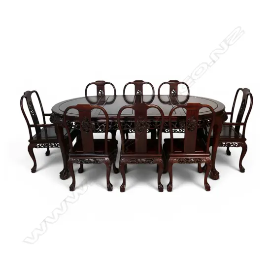 A quality Chinese carved rosewood extension dining table and eight chairs,
