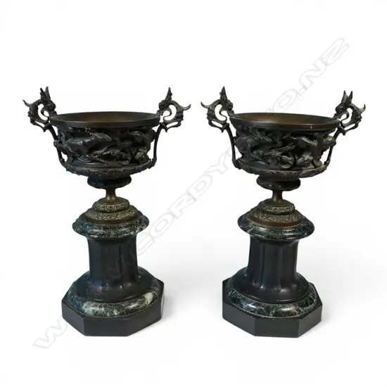 A pair of decorative bronze urns,