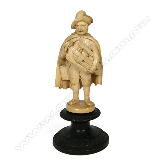 A 19thC European finely caved ivory figure of an itinerant musician with a hurdy-gurdy,