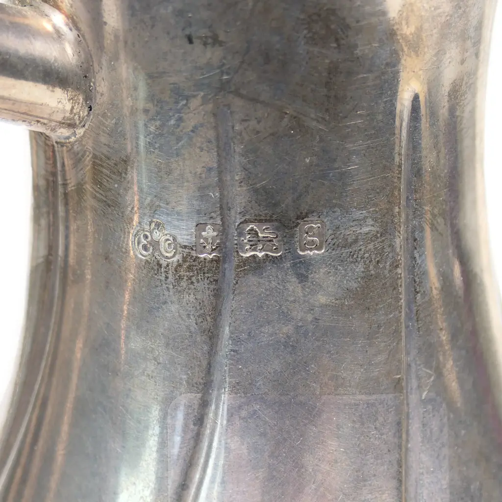 An Edwardian silver hot water pot, fluted ovoid body. Birmingham 1906. Handle plated. 533gms. Image 1++