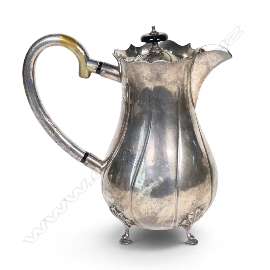 An Edwardian silver hot water pot, fluted ovoid body. Birmingham 1906. Handle plated. 533gms. Image 1++
