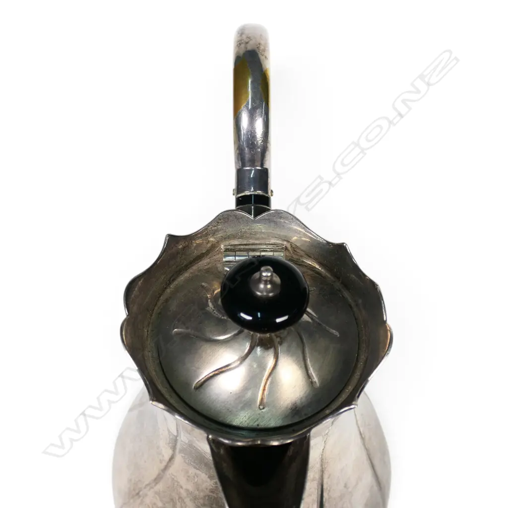 An Edwardian silver hot water pot, fluted ovoid body. Birmingham 1906. Handle plated. 533gms. Image 1++