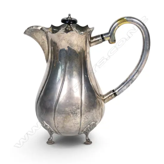 An Edwardian silver hot water pot, fluted ovoid body. Birmingham 1906. Handle plated. 533gms.