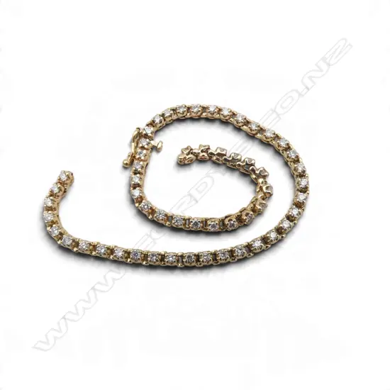 A 9ct gold and diamond tennis bracelet with fifty-five small round brilliant cut diamonds (Colour F-G, Clarity SI2) claw set - push clasp with safety catch. TDW. 1.80ct. 9.60gms. L.200mm. Faults to bracelet LINK DAMAGED AND NEEDS REPAIRING