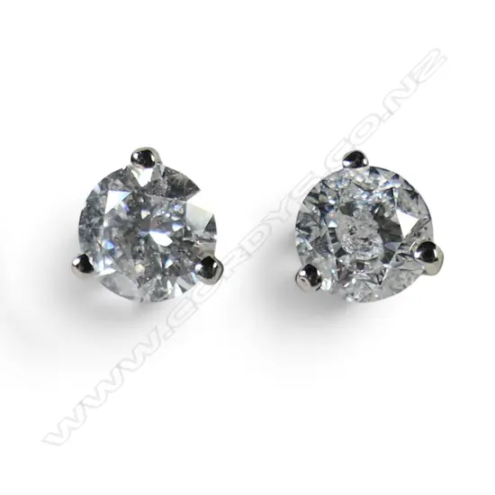 A pair of 14ct white gold and diamond stud earrings,