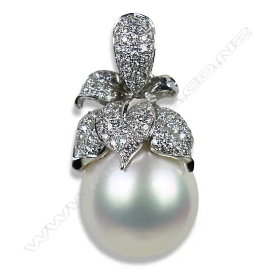 An 18ct white gold diamond and pearl pendant,