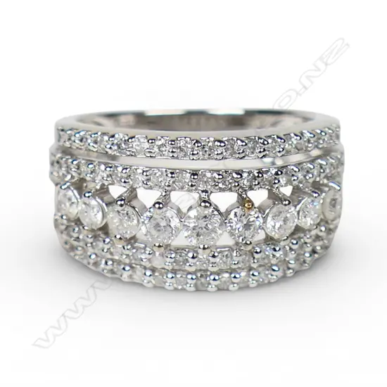 A modern 10ct white gold and multi diamond banded ring,