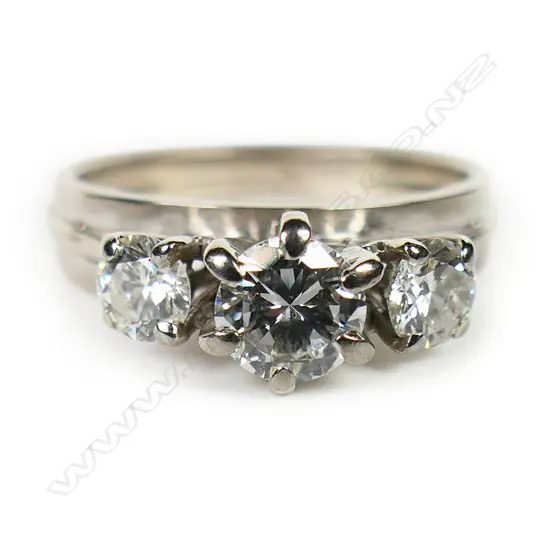 An 18ct white gold and three stone diamond ring,