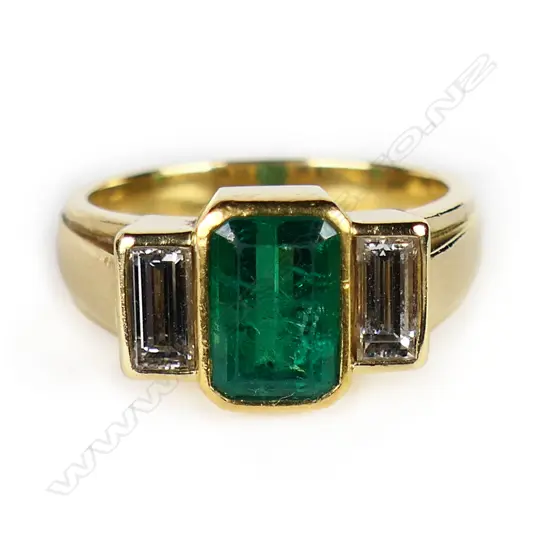 An 18ct gold emerald and diamond ring,