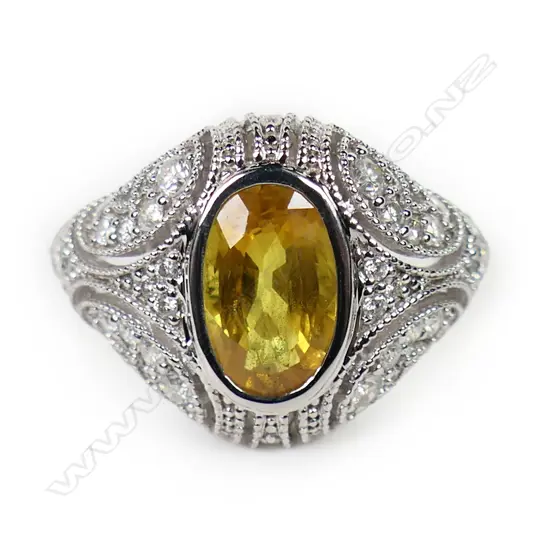A 14ct white gold yellow sapphire and diamond cluster ring,