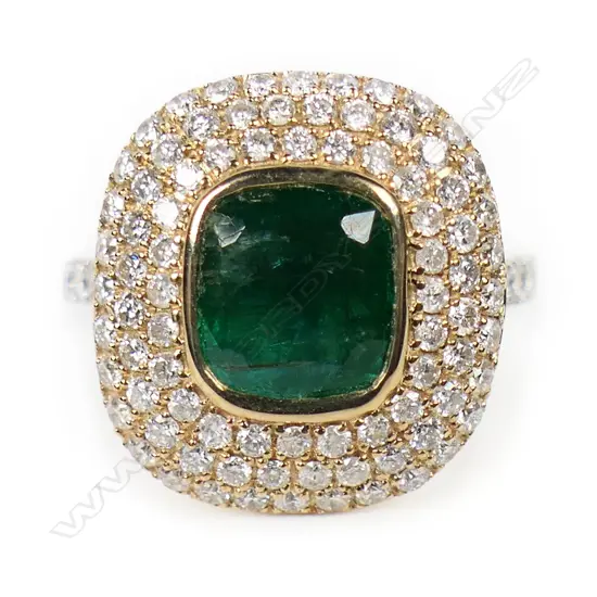 A 14ct white and yellow gold emerald and diamond halo cocktail ring,