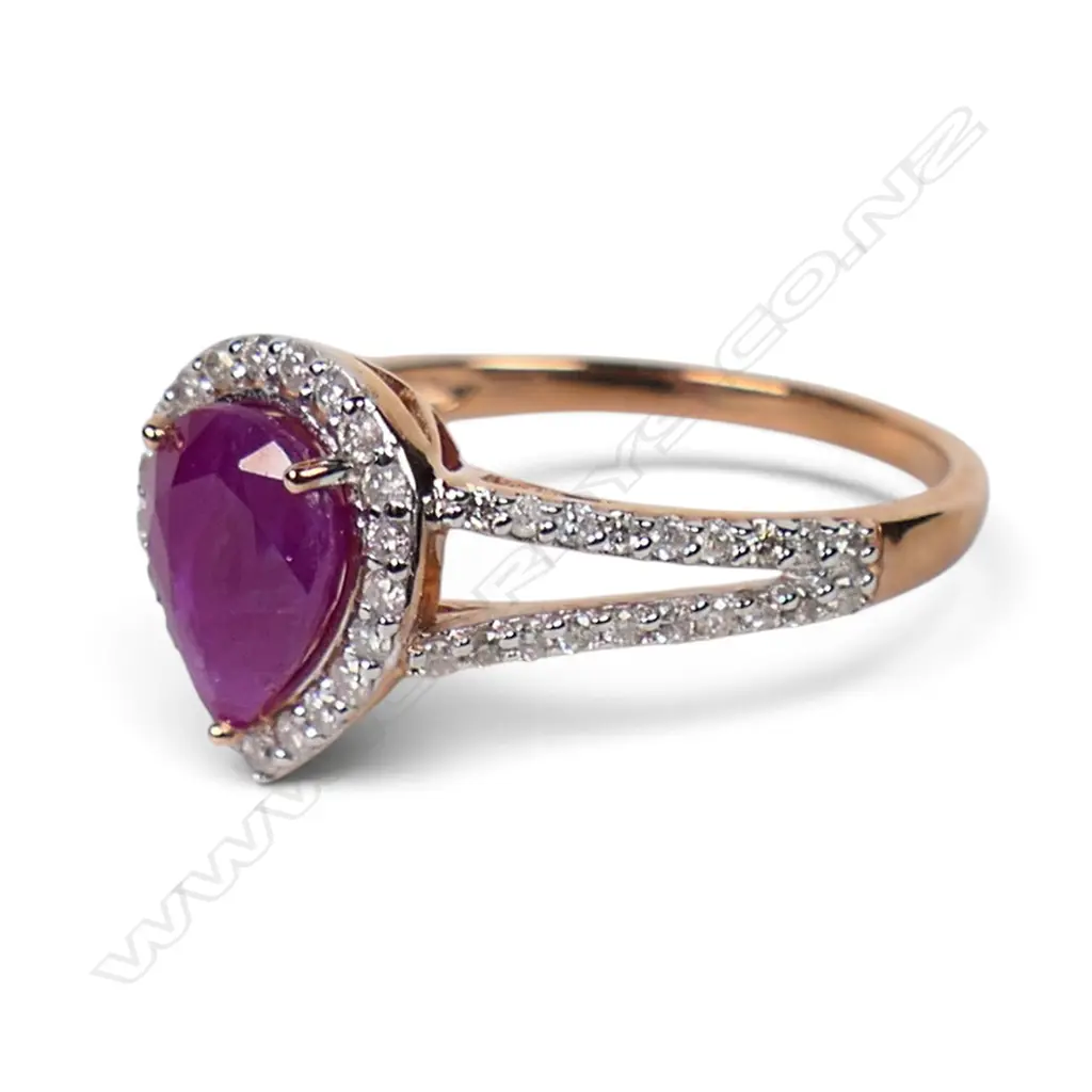 A 14ct rose gold ruby and diamond halo ring, Image 1++