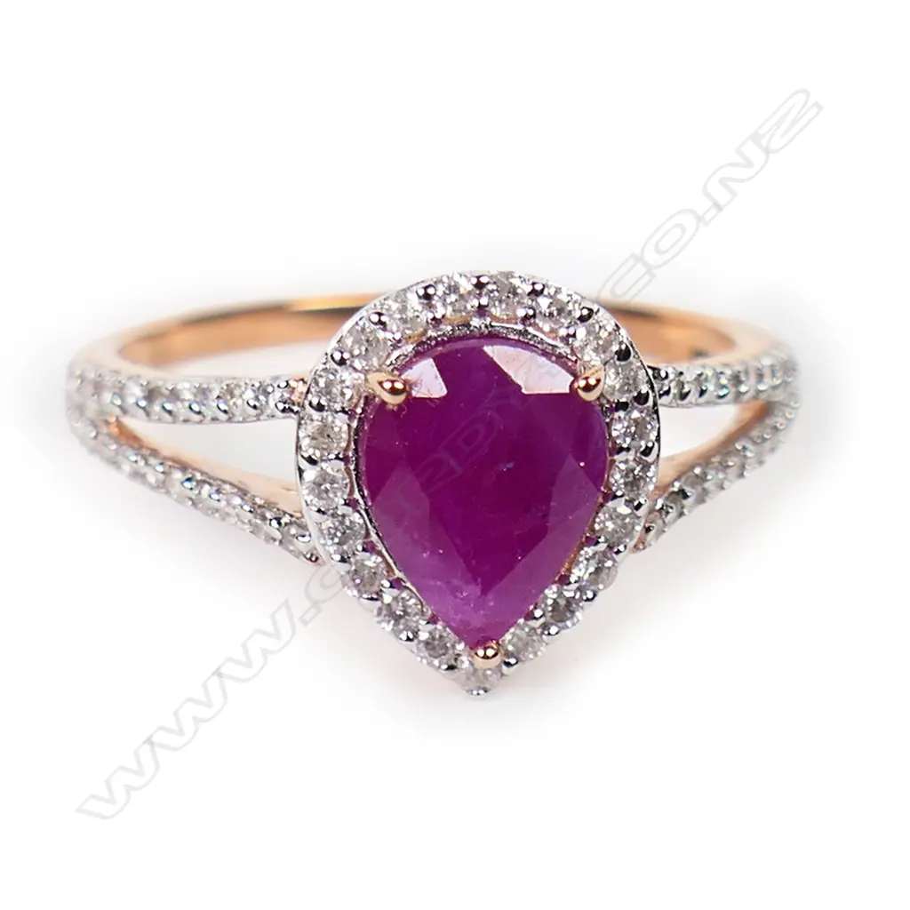A 14ct rose gold ruby and diamond halo ring, Image 1++