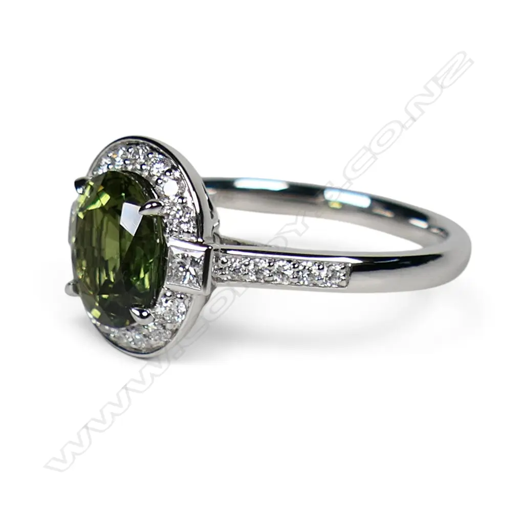An 18ct white gold green sapphire and diamond ring, Image 1++