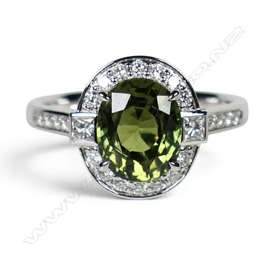 An 18ct white gold green sapphire and diamond ring,