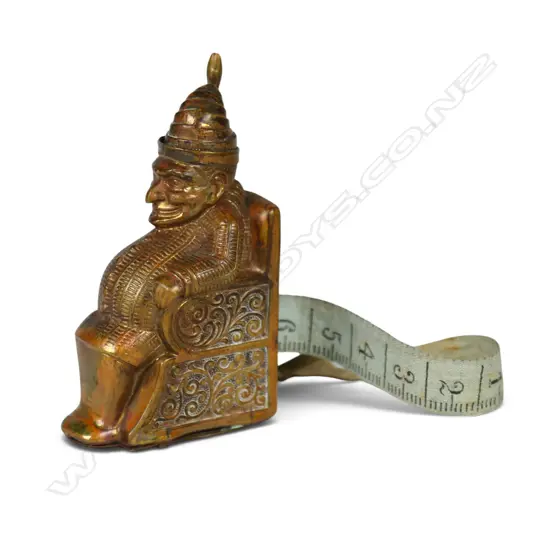 A c.1900 gilt brass Punch sewing tape measure,