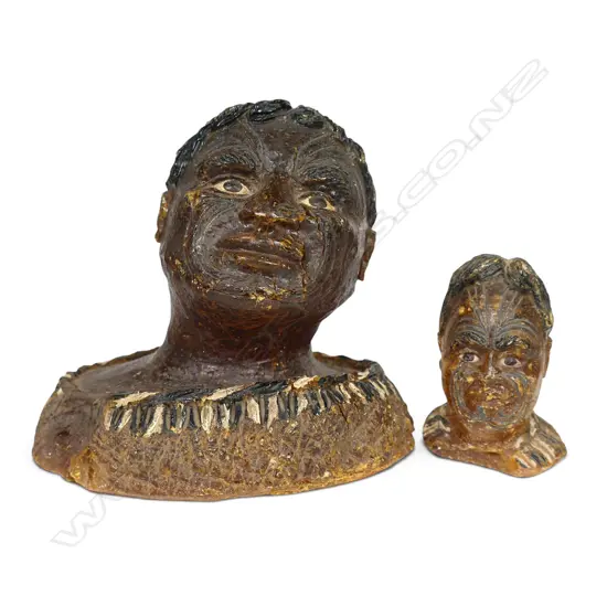 Two late 19thC carved kauri gum heads,