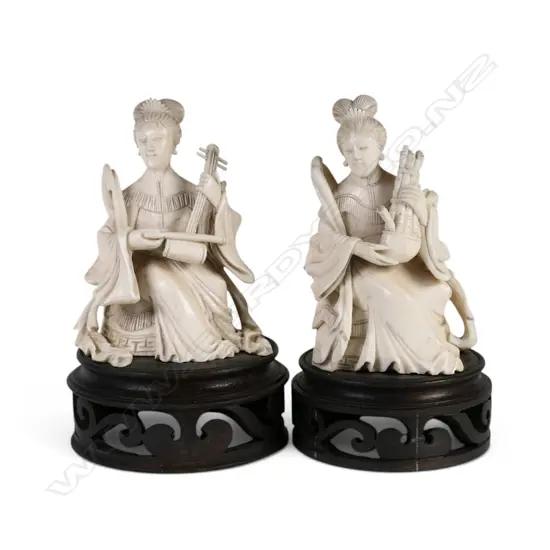 A pair of early 20thC Chinese finely carved ivory female musicians,