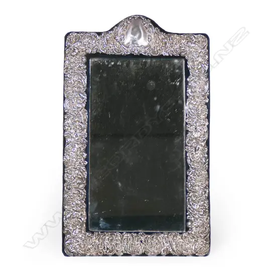 A large Edwardian embossed silver dressing table mirror,